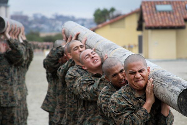 Recruits struggle to lift the front end of the log during log drills aboard Marine Corps Recruit Depot San Diego Dec. 18. Recruits learned how to work together as a team and that if one recruit didn't carry their weight the rest of the group would suffer. (U.S. Marine Corps photo by Lance Cpl. Bridget M. Keane)