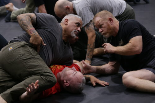 Instructors demonstrating techniques at the Combatives Association Summit.